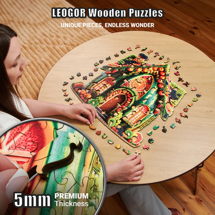 Close-up of 5mm thick wood puzzle piece showing vivid fruit cottage scene and playful shape