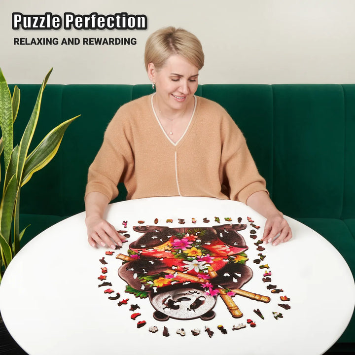 Woman assembling Panda Paradise 500-piece wooden puzzle with bamboo details and wood pieces