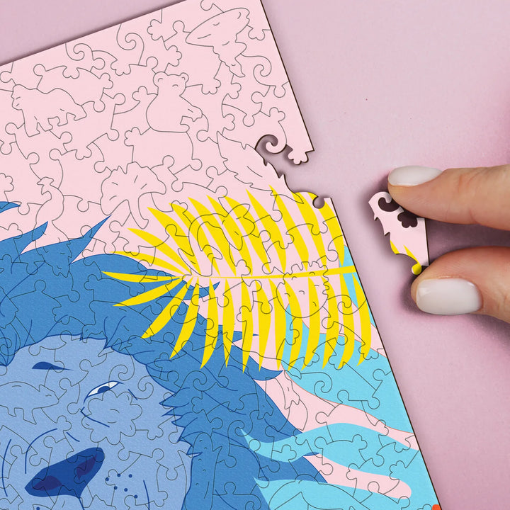 Hands placing uniquely shaped pieces into a wooden jigsaw puzzle for adults – a puzzle challenge.