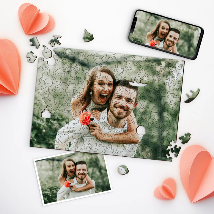Couple smiling and embracing on photo, shown as picture puzzle custom with pieces and hearts