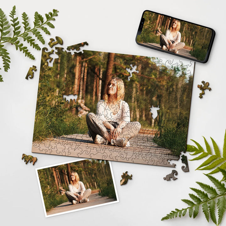 Woman sitting in the forest, photo presented as personalized puzzle with leaves and puzzle pieces