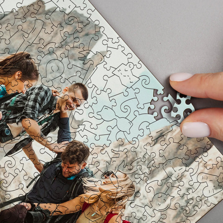 Close-up of an adult picture puzzle and one of its pieces, featuring a travel-themed design